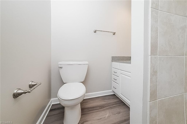 bathroom featuring vanity, toilet, and wood-type flooring