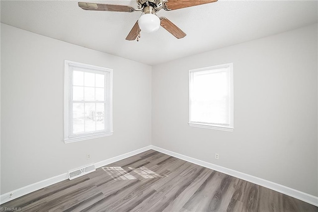 empty room with ceiling fan and hardwood / wood-style flooring