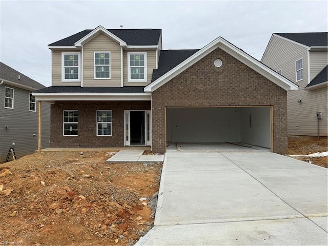 view of front of house with driveway, brick siding, and an attached garage