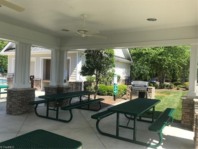 view of patio with outdoor dining space, a ceiling fan, and a grill