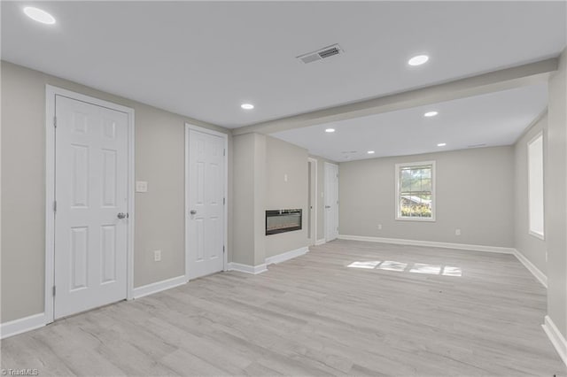 basement with light hardwood / wood-style floors