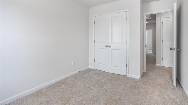 1914 Frost Dr, Haw River, NC 27258 - unfurnished bedroom with light colored carpet, a closet, and baseboards