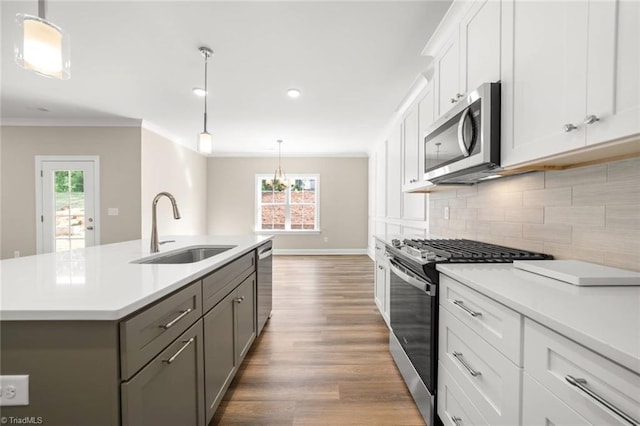 6969 Orchard Path Dr, Clemmons, NC 27012 - kitchen featuring stainless steel appliances, gray cabinetry, light countertops, wood finished floors, and crown molding