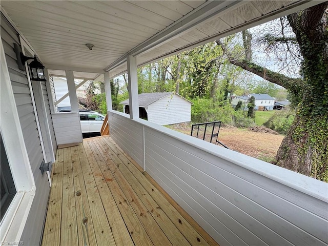 wooden deck with an outbuilding