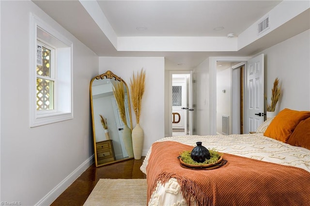 277 Sunset Blvd, Lexington, NC 27292 - bedroom with baseboards, a raised ceiling, and visible vents