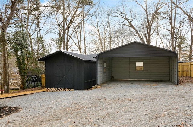 277 Sunset Blvd, Lexington, NC 27292 - garage featuring fence, driveway, a shed, and a detached carport