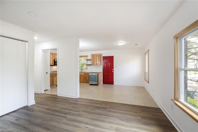 unfurnished living room featuring dark wood-type flooring and sink