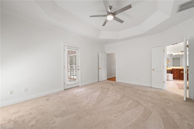 unfurnished bedroom featuring a raised ceiling, carpet flooring, access to outside, crown molding, and baseboards