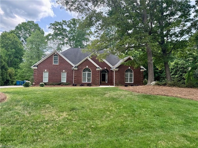 view of front of property with a front yard and brick siding