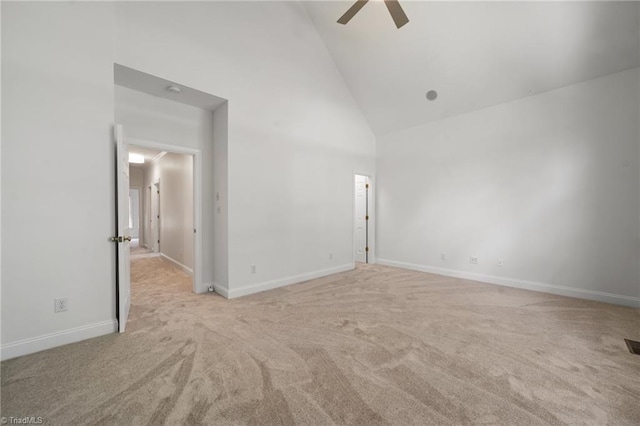 empty room featuring carpet, ceiling fan, high vaulted ceiling, and baseboards