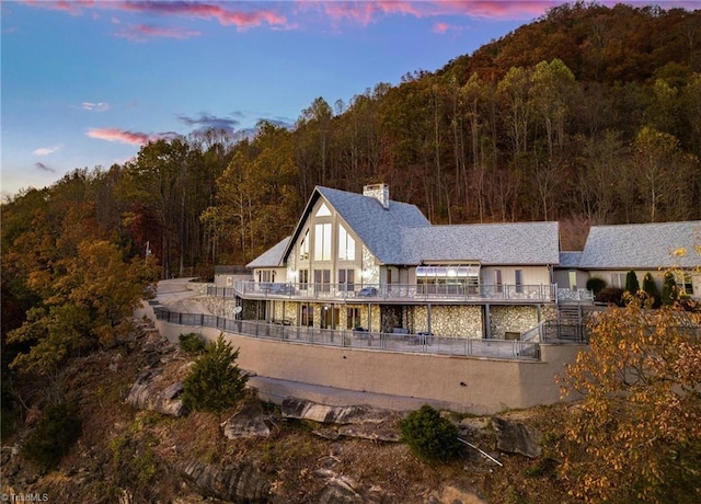 view of back house at dusk