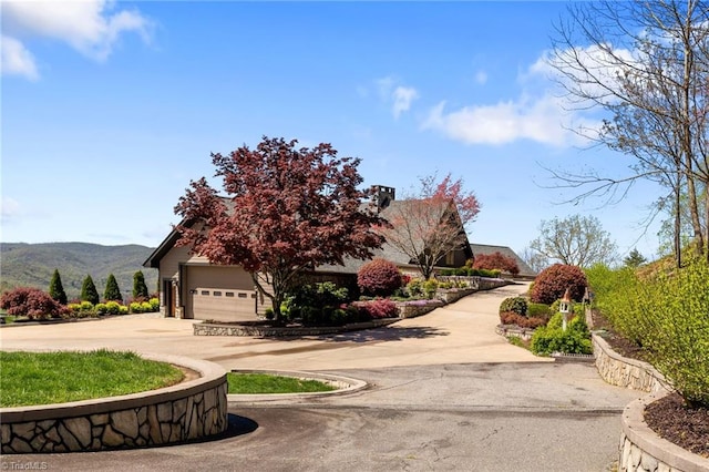 surrounding community featuring a mountain view and a garage