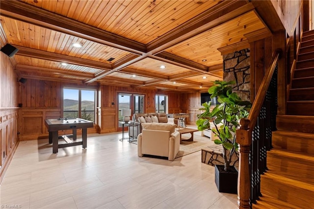 living room featuring coffered ceiling, wood ceiling, wood walls, and beamed ceiling