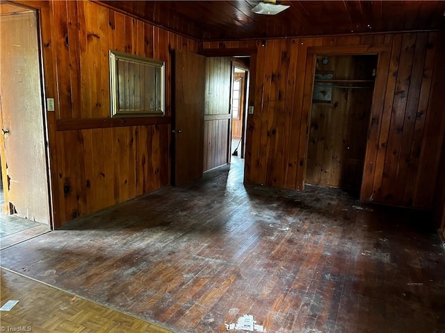 unfurnished room featuring wood ceiling, wooden walls, and dark hardwood / wood-style floors