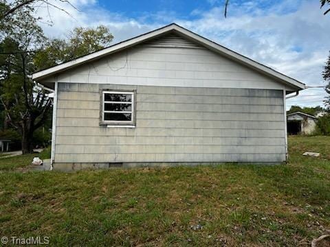 view of side of home featuring a lawn