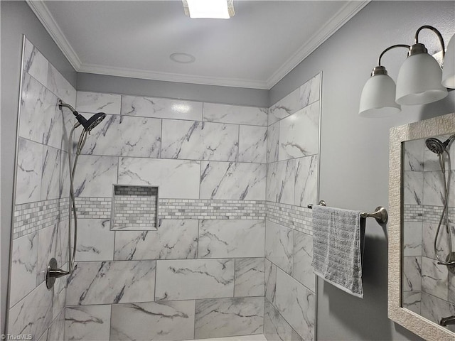 bathroom featuring tiled shower and crown molding