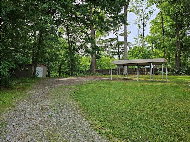 view of yard featuring a garage and an outdoor structure