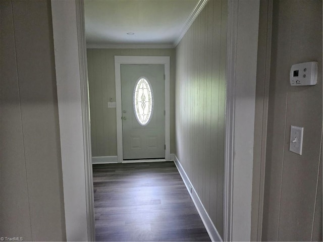 doorway to outside featuring crown molding and dark wood-type flooring