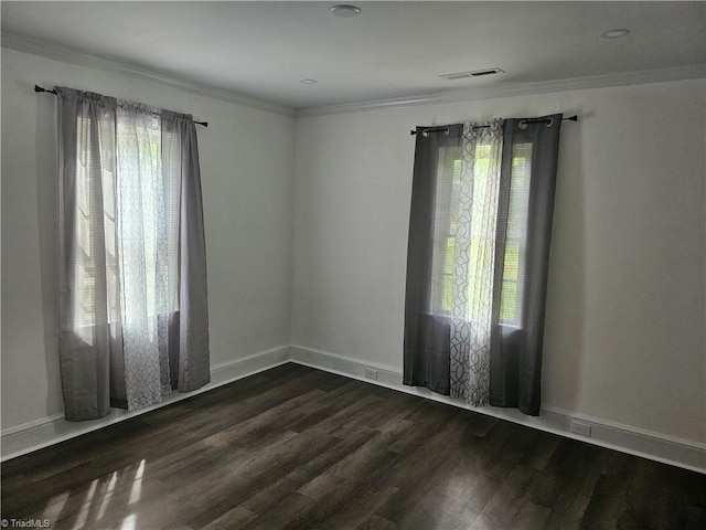 unfurnished room featuring ornamental molding and dark hardwood / wood-style floors