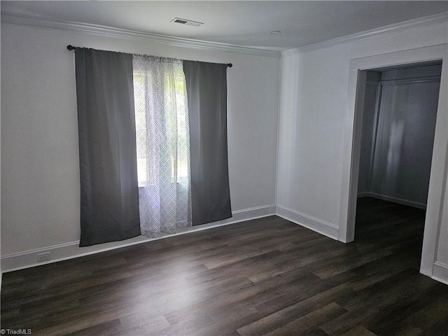 spare room with dark hardwood / wood-style floors and crown molding