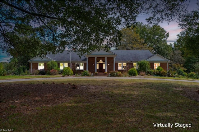 view of front of home with a yard