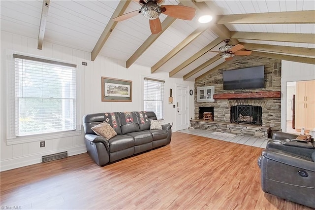 living room with lofted ceiling with beams, wood-type flooring, ceiling fan, and a fireplace