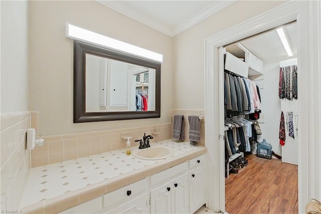 bathroom featuring ornamental molding, vanity, and hardwood / wood-style floors