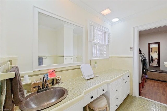 bathroom featuring vanity, tile flooring, crown molding, and tasteful backsplash