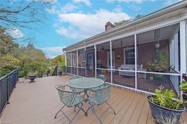 wooden deck featuring a sunroom