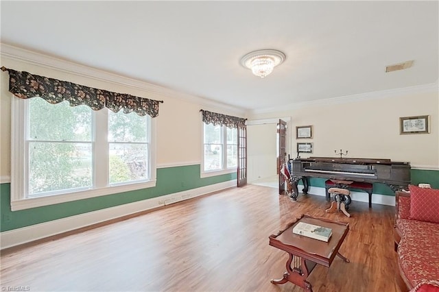 living room with ornamental molding and hardwood / wood-style flooring