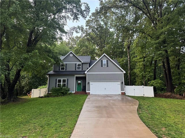 385 Apache Dr, Winston-Salem, NC 27107 - traditional-style house featuring a gate, driveway, view of scattered trees, and a garage