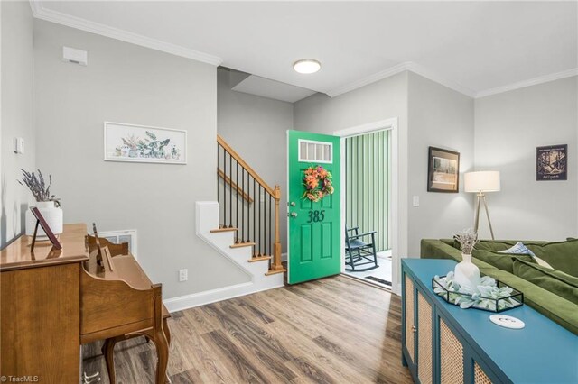 385 Apache Dr, Winston-Salem, NC 27107 - foyer featuring wood finished floors, crown molding, stairs, and baseboards
