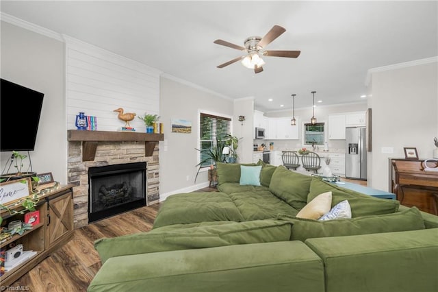 385 Apache Dr, Winston-Salem, NC 27107 - living area with ceiling fan, wood finished floors, ornamental molding, a fireplace, and baseboards