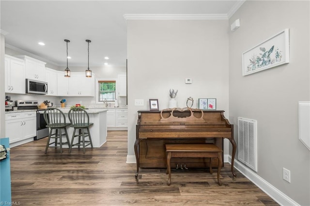 385 Apache Dr, Winston-Salem, NC 27107 - dining room with ornamental molding, dark wood finished floors, recessed lighting, and baseboards