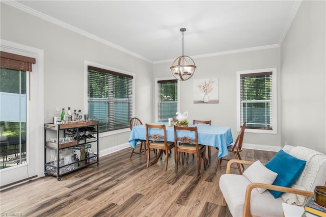 385 Apache Dr, Winston-Salem, NC 27107 - dining area featuring a chandelier, wood finished floors, crown molding, baseboards, and plenty of natural light