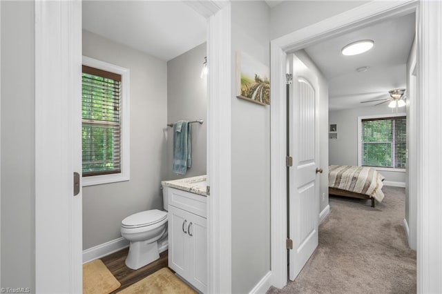 385 Apache Dr, Winston-Salem, NC 27107 - bathroom featuring toilet, vanity, baseboards, and ceiling fan