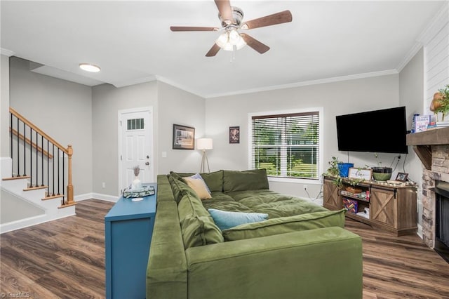 385 Apache Dr, Winston-Salem, NC 27107 - living area featuring a stone fireplace, dark wood-type flooring, stairs, a ceiling fan, and crown molding