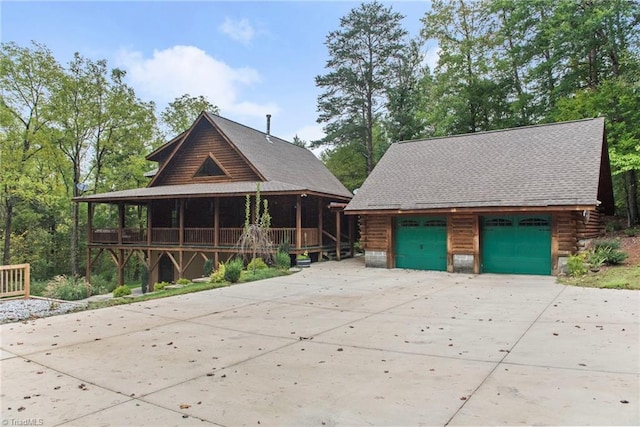 log-style house with an outbuilding and a garage