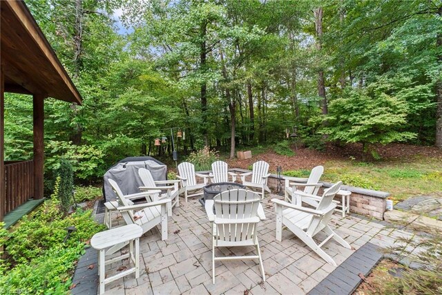 view of patio / terrace with an outdoor fire pit and a grill