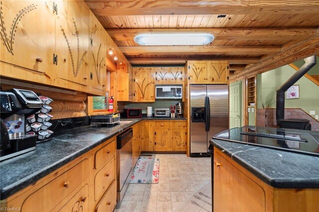 kitchen featuring beam ceiling, appliances with stainless steel finishes, wood ceiling, and a wood stove