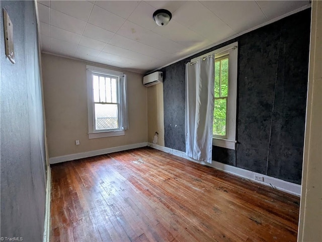 423 Tate St, High Point, NC 27260 - empty room with healthy amount of natural light, hardwood / wood-style floors, a wall unit AC, and ornamental molding