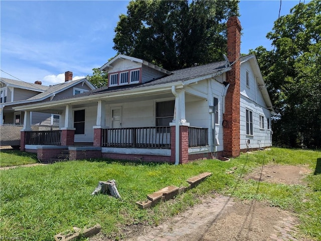 423 Tate St, High Point, NC 27260 - bungalow featuring a porch, a chimney, and a shingled roof