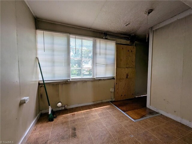 423 Tate St, High Point, NC 27260 - unfurnished room with tile patterned flooring and baseboards