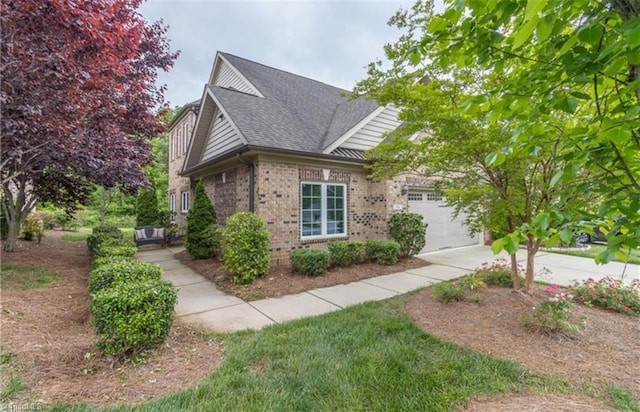 view of property exterior with a shingled roof, brick siding, driveway, and a garage