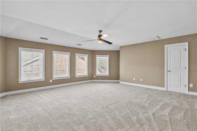 spare room featuring a ceiling fan, carpet flooring, visible vents, and baseboards