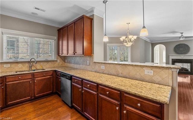 kitchen featuring a sink, a peninsula, dark wood finished floors, and stainless steel dishwasher