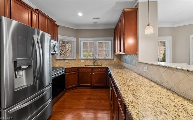 kitchen with light stone counters, dark wood-style flooring, appliances with stainless steel finishes, ornamental molding, and a sink