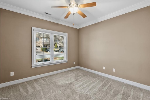 carpeted spare room featuring baseboards, visible vents, ceiling fan, and ornamental molding