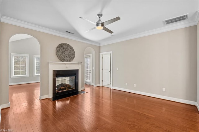 unfurnished living room with a fireplace, visible vents, and a healthy amount of sunlight