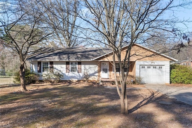 ranch-style house with a garage and driveway